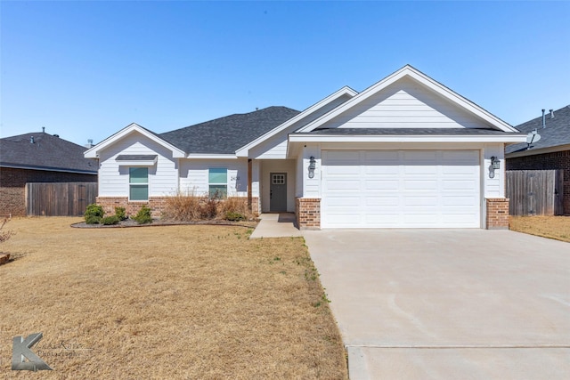 view of front of home with a garage, driveway, brick siding, and fence