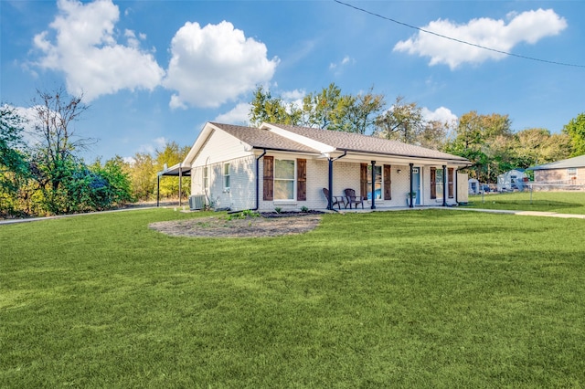 view of front of home featuring brick siding, central AC unit, and a front yard