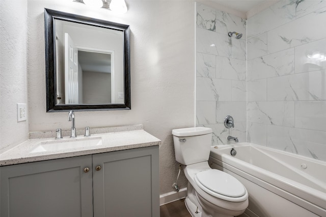 full bath featuring shower / bath combination, baseboards, a textured wall, toilet, and vanity