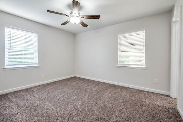 carpeted empty room with plenty of natural light and baseboards