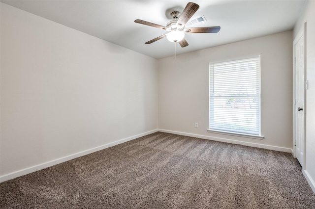 carpeted empty room with ceiling fan, visible vents, and baseboards