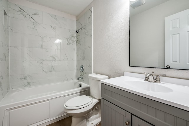 full bath with a textured wall, toilet, wood finished floors, vanity, and shower / washtub combination