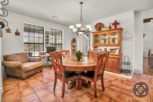 dining area with tile patterned flooring, high vaulted ceiling, baseboards, and a ceiling fan