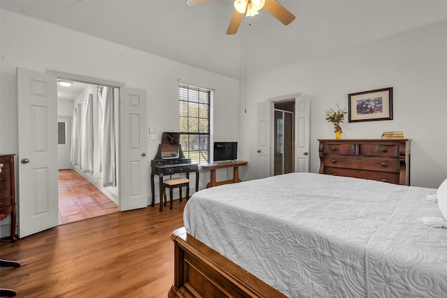 bedroom with vaulted ceiling, ceiling fan, and wood finished floors