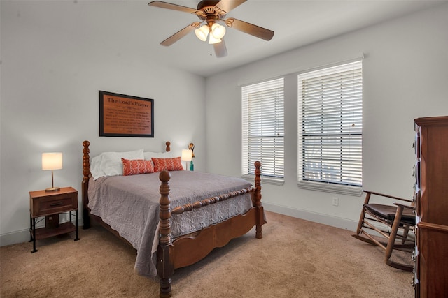 bedroom with a ceiling fan, light colored carpet, and baseboards