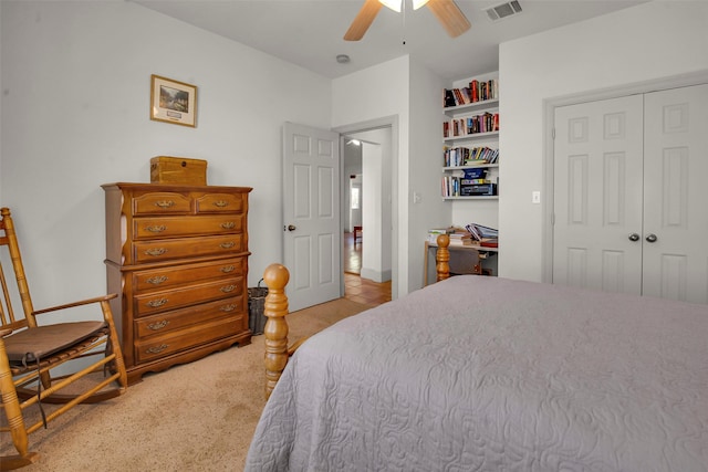 bedroom featuring a closet, visible vents, light carpet, and ceiling fan