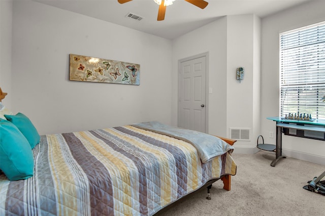 carpeted bedroom featuring visible vents and ceiling fan