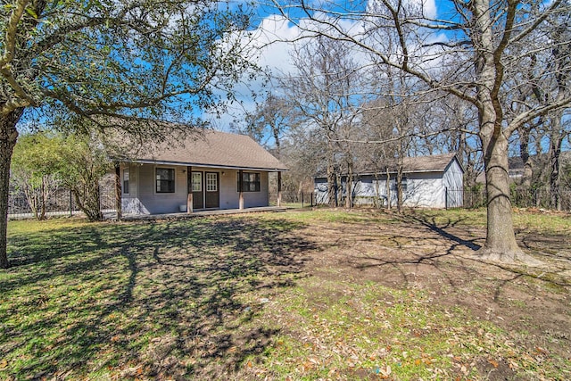 exterior space featuring a yard, fence, and covered porch