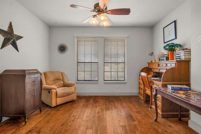 office space featuring baseboards, a ceiling fan, and hardwood / wood-style flooring