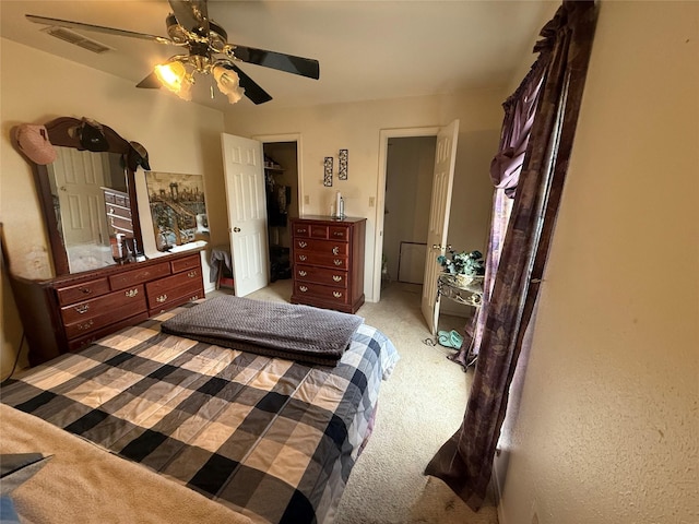 bedroom featuring ceiling fan, light carpet, and visible vents