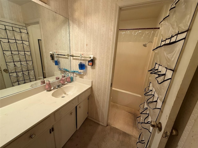 bathroom with wallpapered walls, shower / tub combo with curtain, and vanity