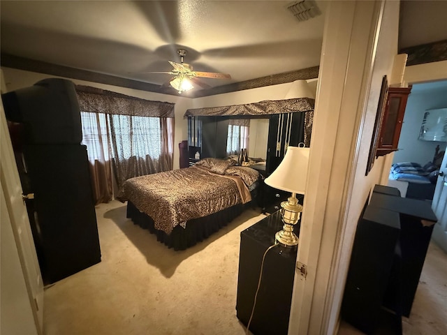 bedroom featuring ceiling fan, carpet, and visible vents