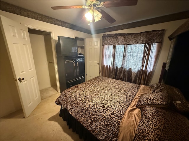 bedroom with a ceiling fan and light colored carpet