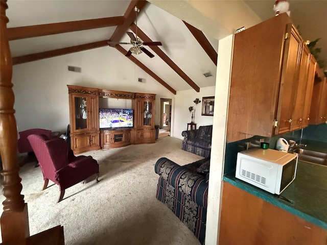 carpeted living room featuring ceiling fan, high vaulted ceiling, a sink, visible vents, and beam ceiling