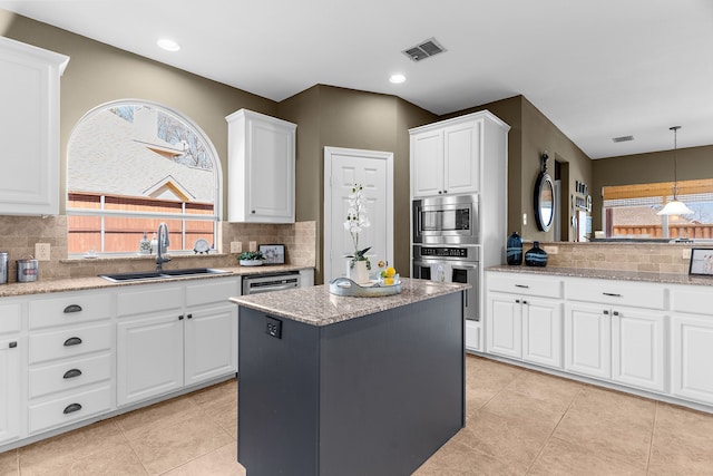 kitchen with a sink, plenty of natural light, visible vents, and stainless steel appliances