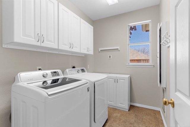 washroom with light tile patterned floors, cabinet space, independent washer and dryer, and baseboards