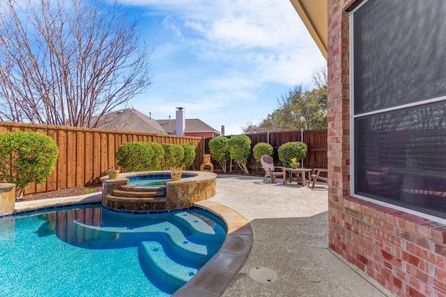 view of pool with a fenced in pool, an in ground hot tub, a fenced backyard, and a patio