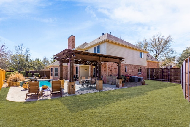 rear view of house featuring a fenced backyard, a pergola, a patio, and brick siding