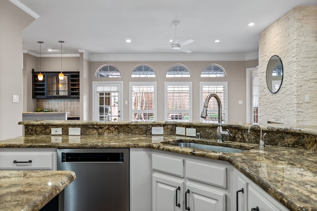 kitchen with white cabinets, crown molding, backsplash, and stainless steel dishwasher