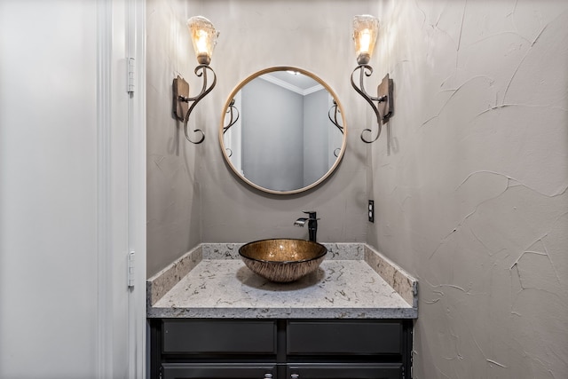 bathroom featuring ornamental molding and vanity