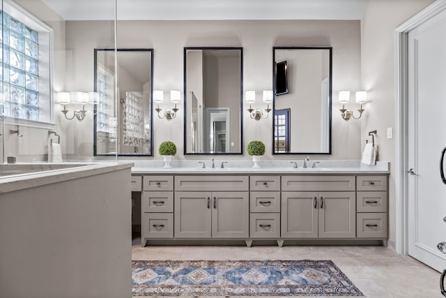 bathroom with double vanity, a sink, and tile patterned floors