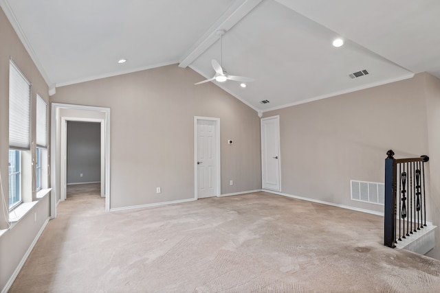 spare room featuring vaulted ceiling with beams, visible vents, and light colored carpet