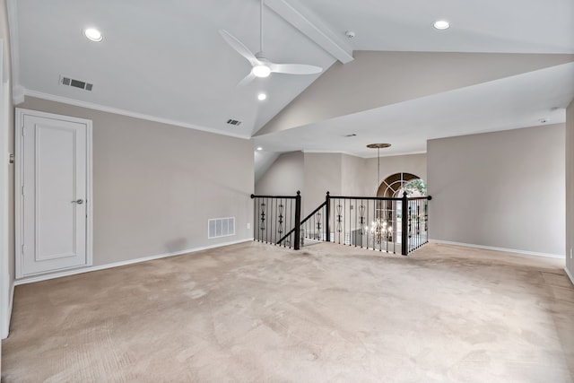 spare room featuring ceiling fan with notable chandelier, carpet floors, beam ceiling, and visible vents