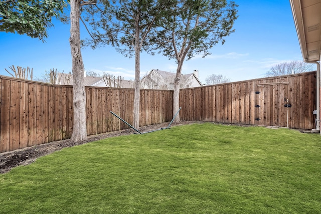 view of yard with a fenced backyard