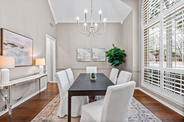 dining room featuring ornamental molding, visible vents, dark wood-type flooring, and an inviting chandelier