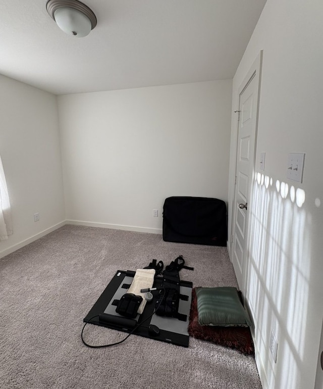 carpeted bedroom featuring multiple windows and baseboards