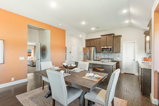 dining room featuring lofted ceiling, recessed lighting, visible vents, baseboards, and dark wood finished floors