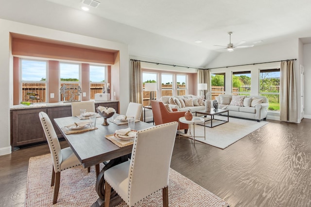 dining space featuring lofted ceiling, dark wood-type flooring, plenty of natural light, and a ceiling fan