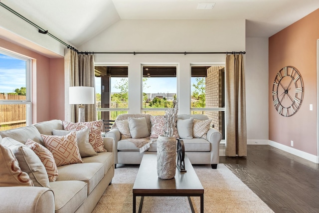 living area featuring vaulted ceiling, light wood-style flooring, and baseboards