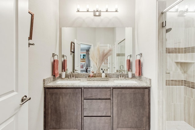 ensuite bathroom featuring double vanity, a shower stall, a sink, and ensuite bathroom