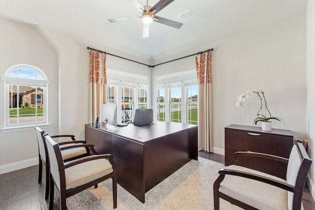 office space with baseboards, wood finished floors, visible vents, and a ceiling fan