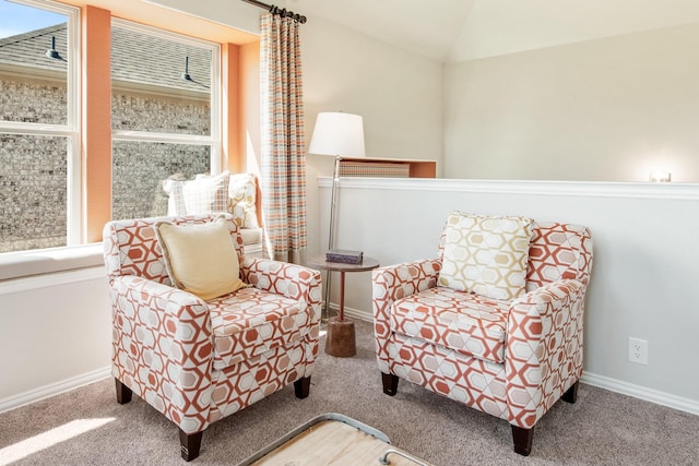 sitting room featuring carpet floors, baseboards, and vaulted ceiling