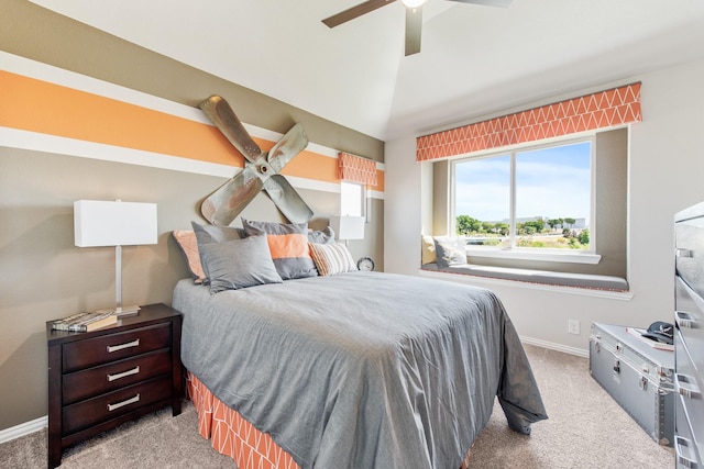 bedroom with carpet floors, vaulted ceiling, baseboards, and ceiling fan