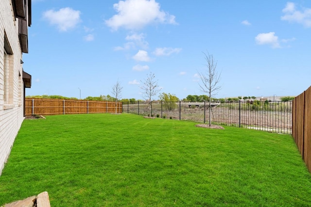 view of yard with a fenced backyard