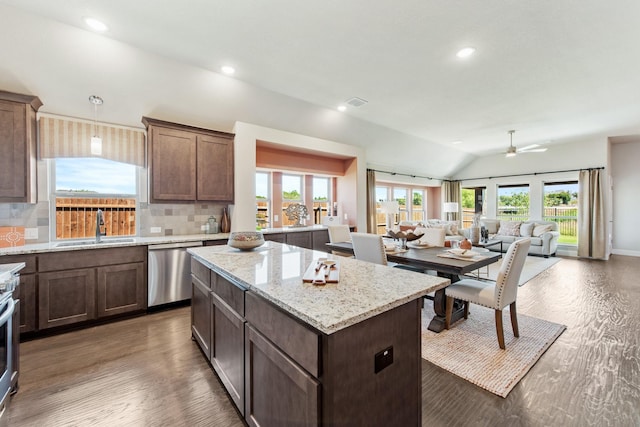 kitchen with a center island, a sink, stainless steel dishwasher, and wood finished floors