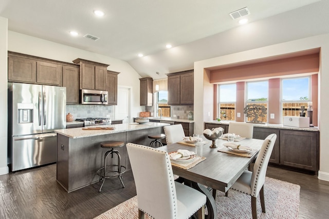 dining room with dark wood-style floors, visible vents, vaulted ceiling, and recessed lighting