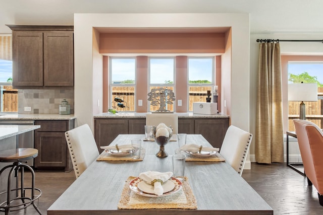 dining space with dark wood-type flooring and plenty of natural light