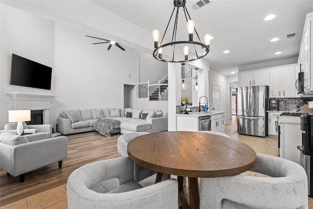 dining room featuring recessed lighting, a fireplace, visible vents, and light tile patterned floors