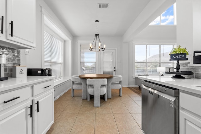 kitchen with visible vents, a chandelier, light tile patterned floors, white cabinets, and stainless steel dishwasher