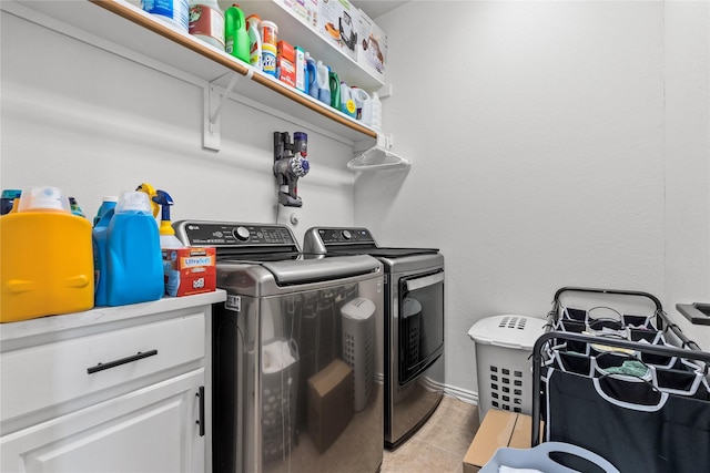 washroom with washer and dryer, laundry area, and light tile patterned floors