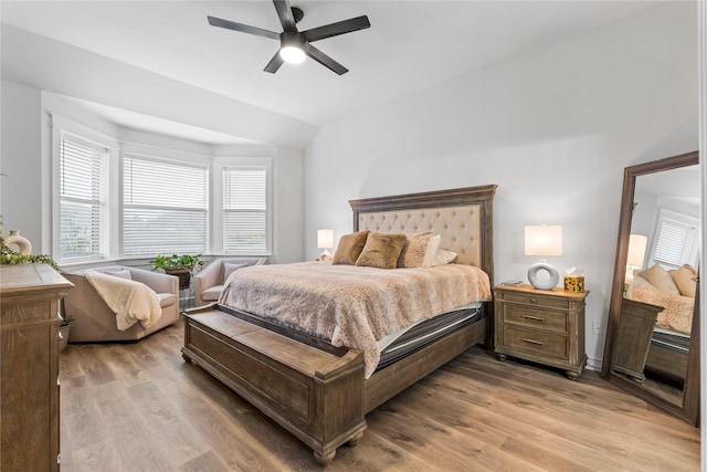 bedroom with light wood-style flooring, ceiling fan, and vaulted ceiling