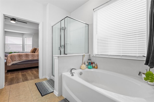 ensuite bathroom featuring tile patterned floors, a stall shower, ensuite bathroom, and a garden tub