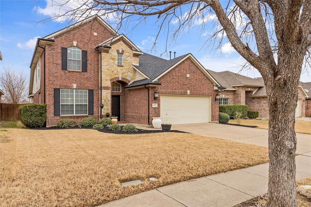 traditional home with concrete driveway, a front lawn, a garage, stone siding, and brick siding