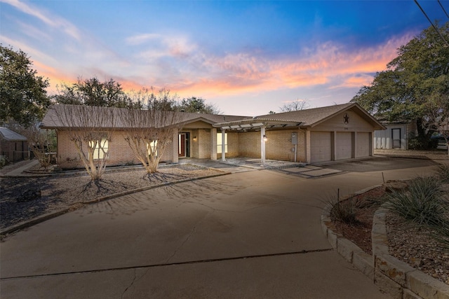 view of front of house with a garage, driveway, and brick siding