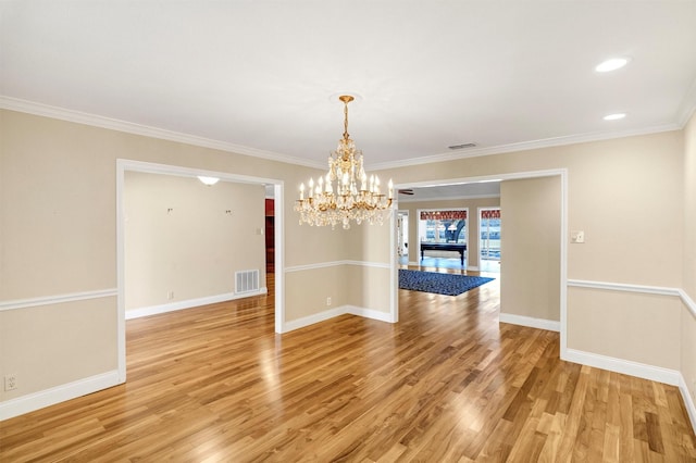 unfurnished dining area featuring visible vents, crown molding, light wood-style flooring, and baseboards