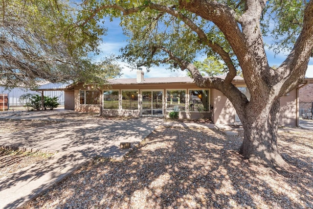 ranch-style home with a chimney